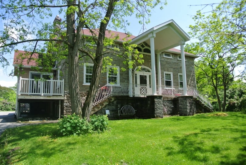 Historically designated 1830s one-and-a-half storey Ontario vernacular limestone dwelling