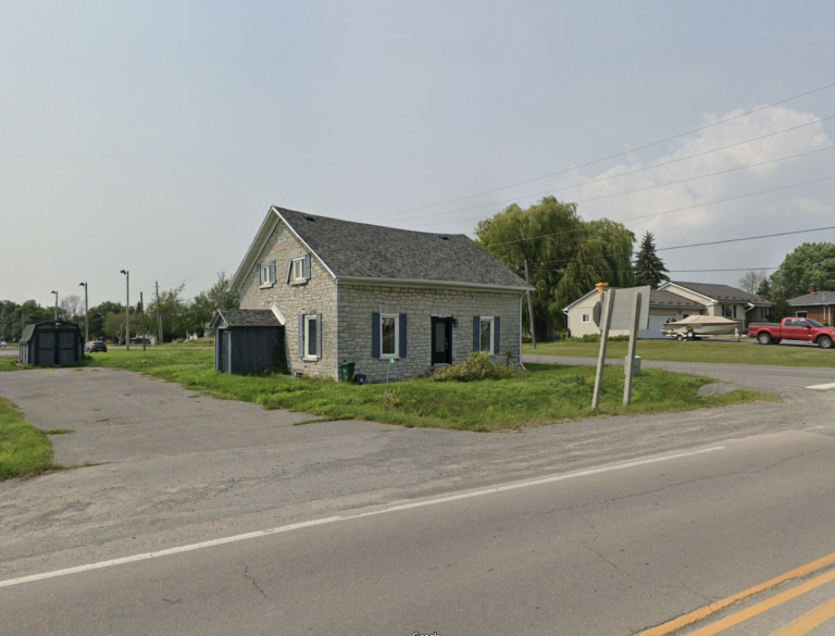 One and a half story historic, limestone farmhouse with a central doorway and windows on either side